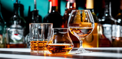 Strong hard alcoholic drinks, spirits, distillates, whiskey and others in glasses and bottles