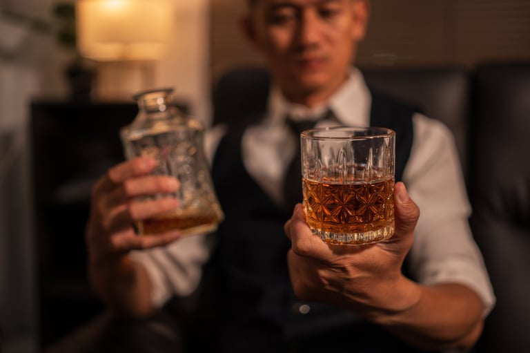 Businessman holding a glass of whiskey in a relaxed setting