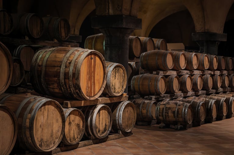 Traditional cellar with stacked wood barrels in a rustic vault, warm light and whisky aging atmosphere