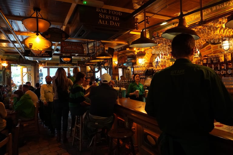 Interior view of a busy traditional Irish pub in Dublin with warm atmospheric lighting
